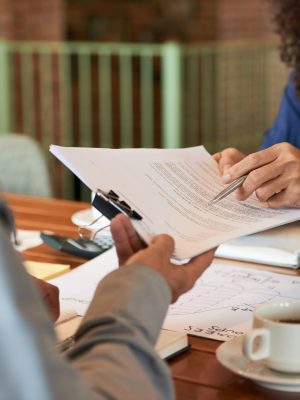 Businessman consulting with lawyer before signing contract